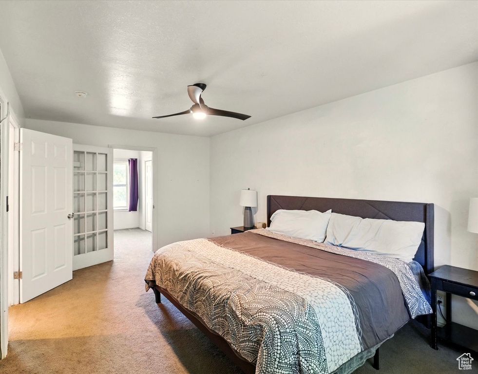 Bedroom featuring light carpet and ceiling fan