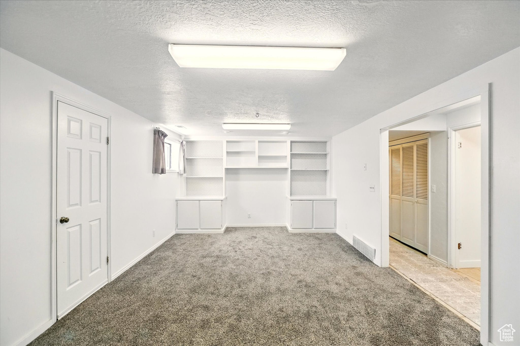 Spacious closet with light carpet