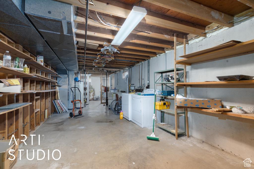 Unfinished basement featuring separate washer and dryer and water heater