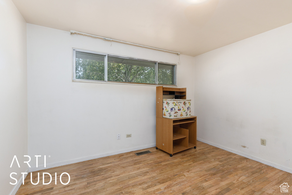 Spare room featuring wood finished floors and baseboards