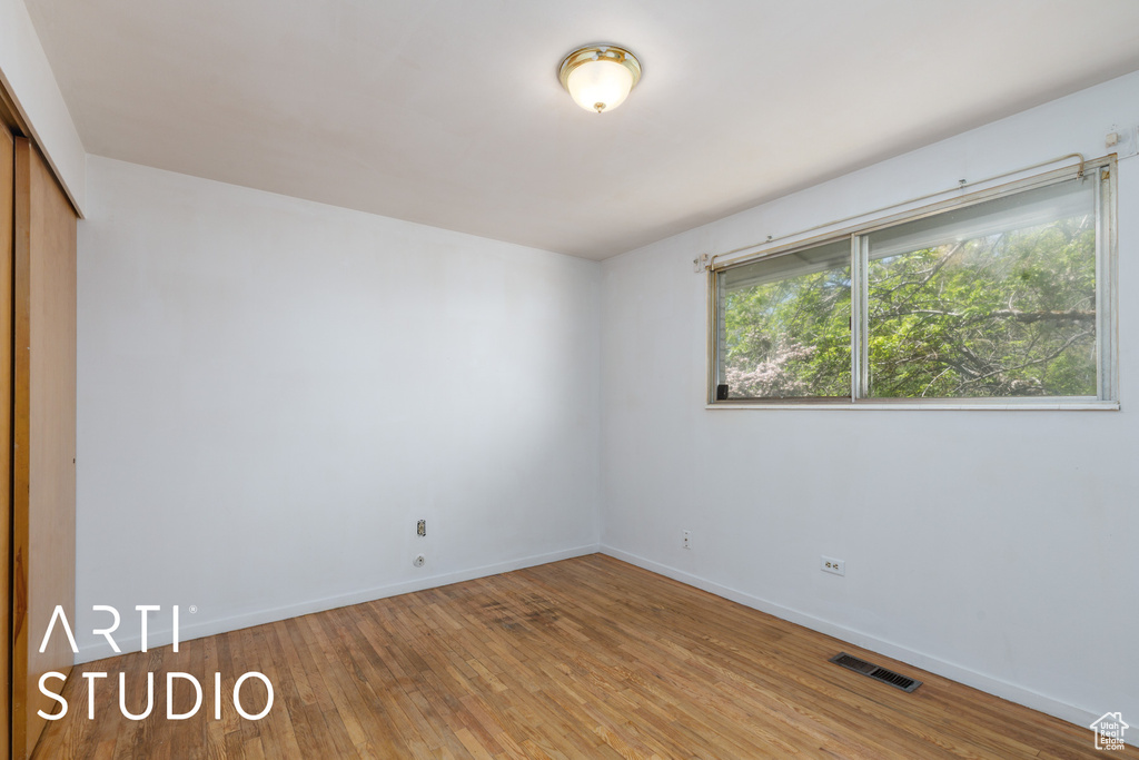 Spare room featuring light wood finished floors and baseboards
