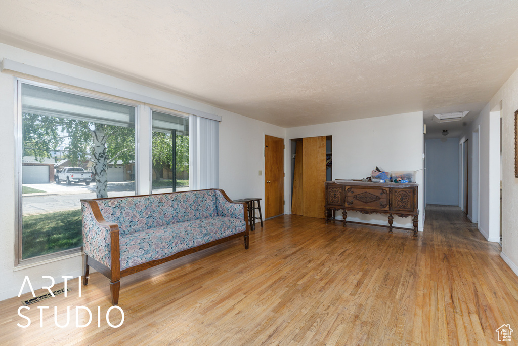 Living area with light wood finished floors and baseboards