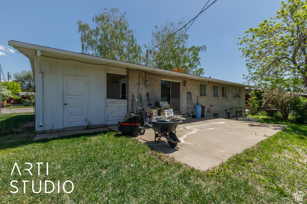 Back of property featuring a patio and brick siding