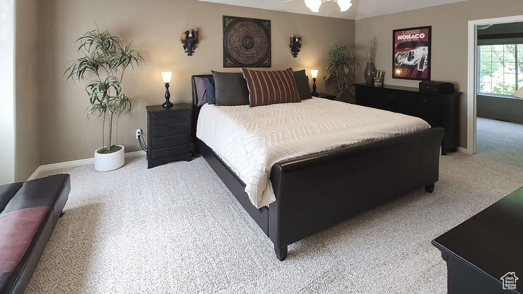 Bedroom featuring light carpet and baseboards