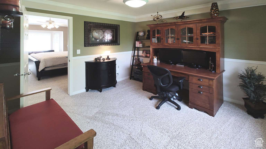 Office area featuring light carpet, ceiling fan, and ornamental molding