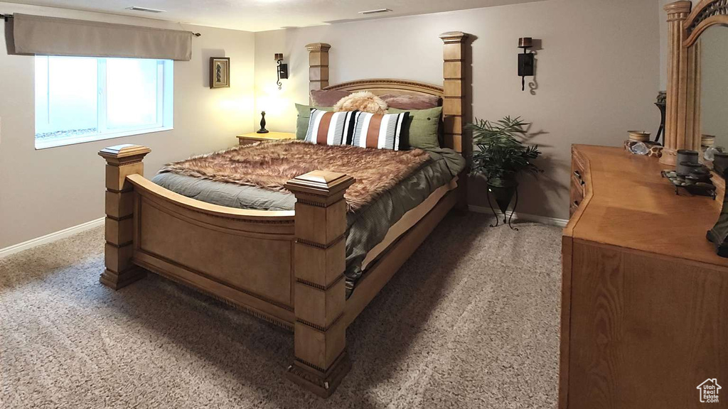 Bedroom featuring carpet and baseboards