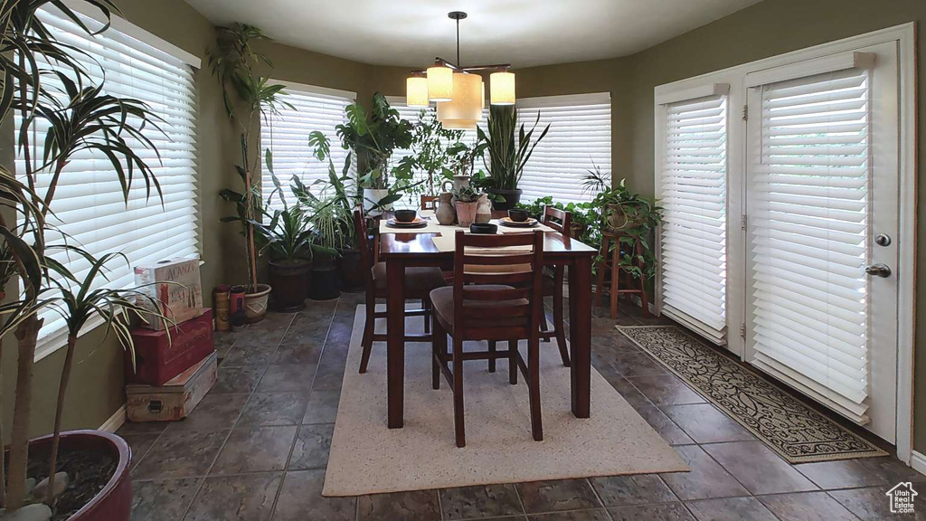 Dining area featuring baseboards and a chandelier