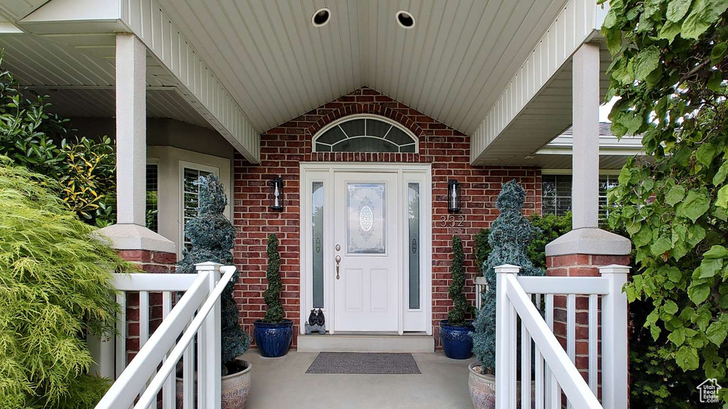 Doorway to property featuring brick siding