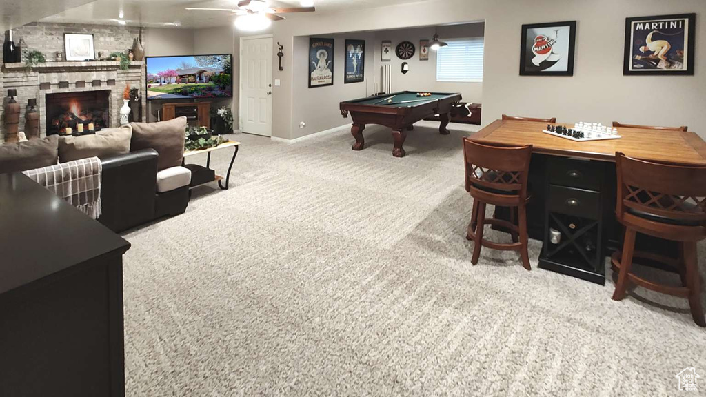 Playroom with carpet, a stone fireplace, billiards table, baseboards, and ceiling fan