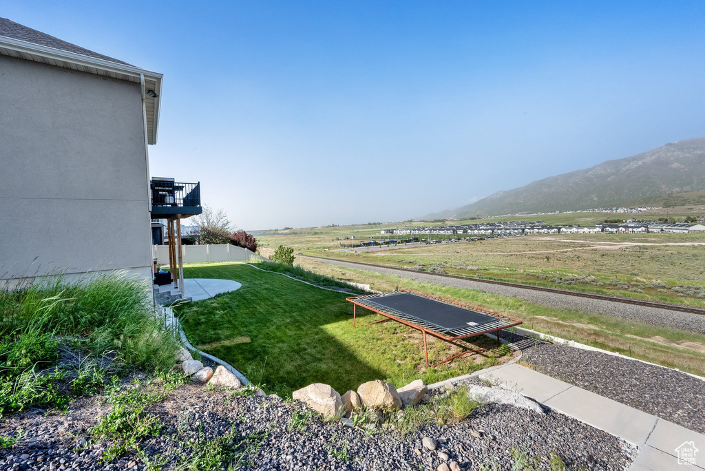 View of grassy yard with a mountain view