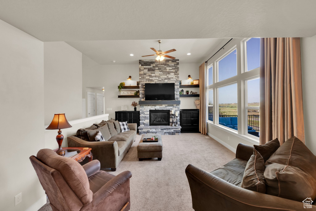 Living area with a ceiling fan, carpet floors, a fireplace, baseboards, and recessed lighting