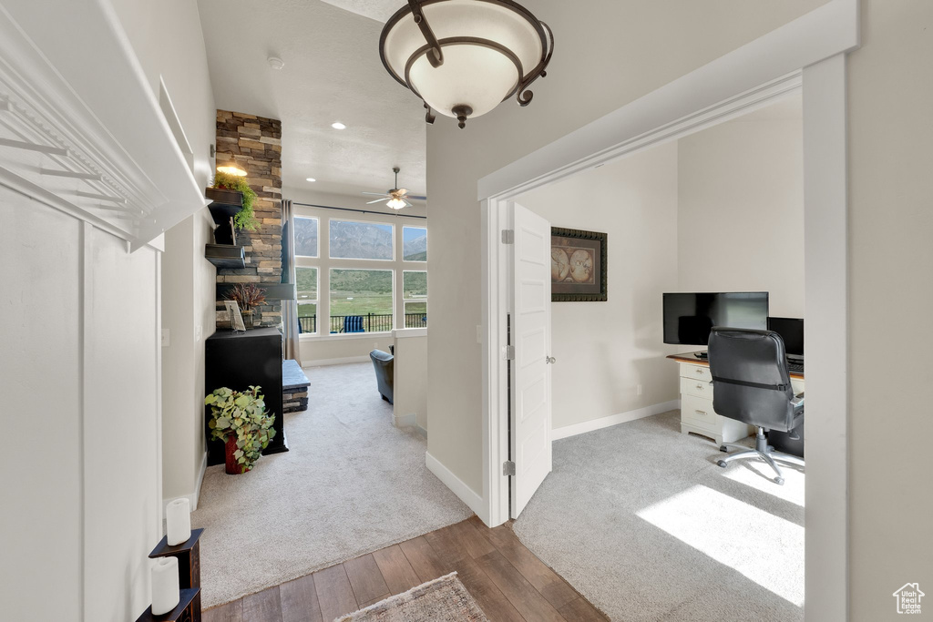 Carpeted office with hardwood / wood-style floors, recessed lighting, ceiling fan, and baseboards