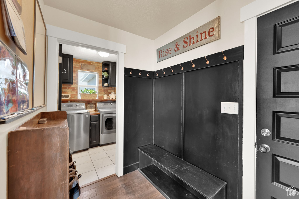 Mudroom with washing machine and clothes dryer and wood finished floors