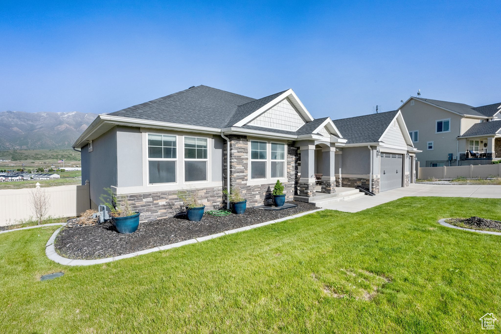 Craftsman inspired home with stone siding, concrete driveway, an attached garage, and a shingled roof