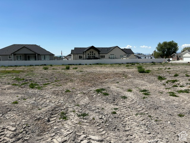 View of yard featuring fence and a residential view