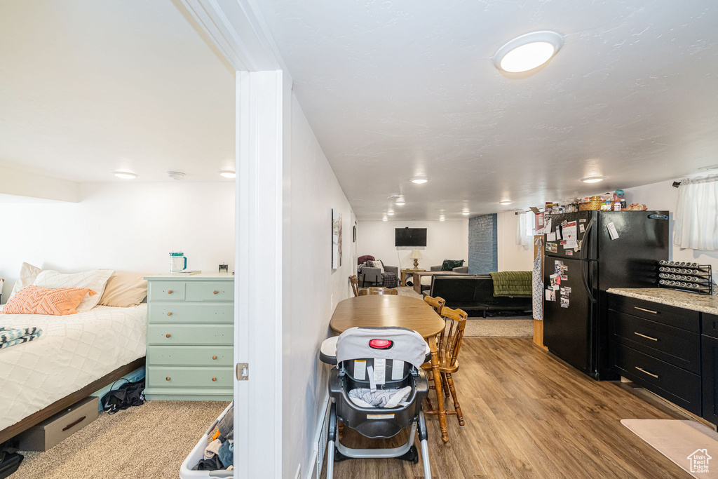 Bedroom featuring freestanding refrigerator and light wood finished floors