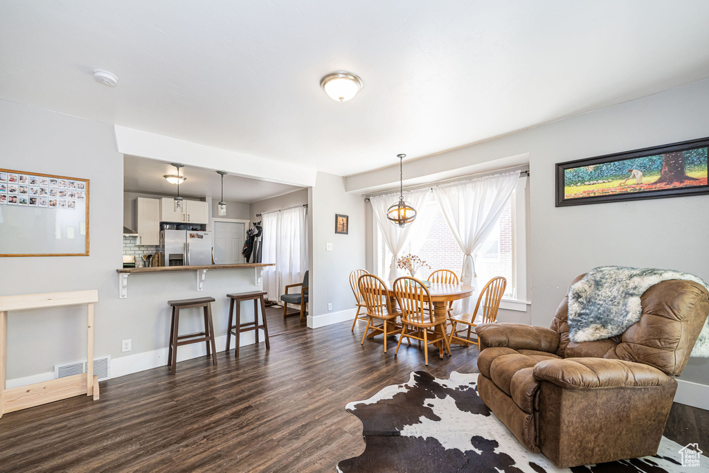 Living area with dark wood-type flooring and baseboards