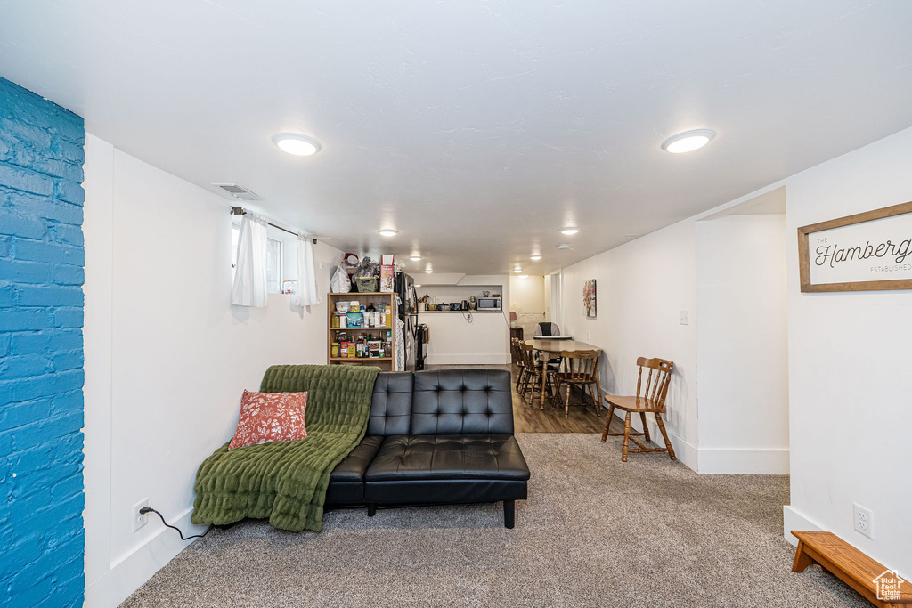 Sitting room with carpet floors, baseboards, and recessed lighting