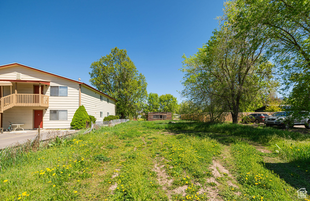 View of yard with a balcony