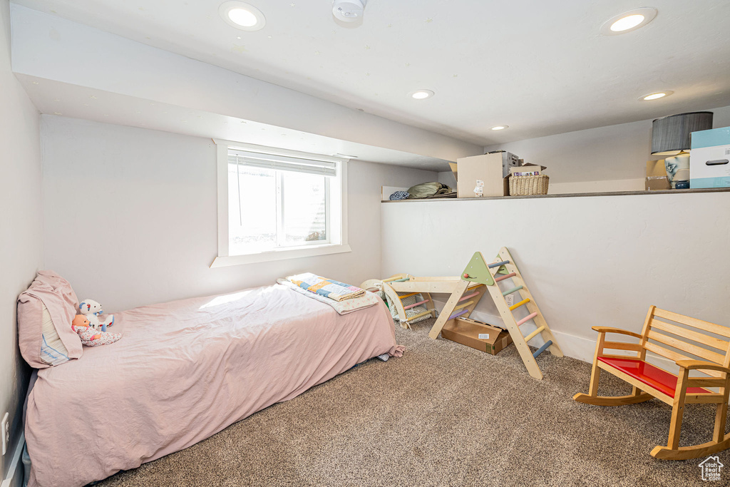 Carpeted bedroom with recessed lighting