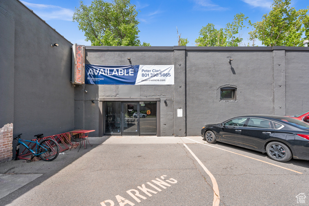 View of property featuring uncovered parking