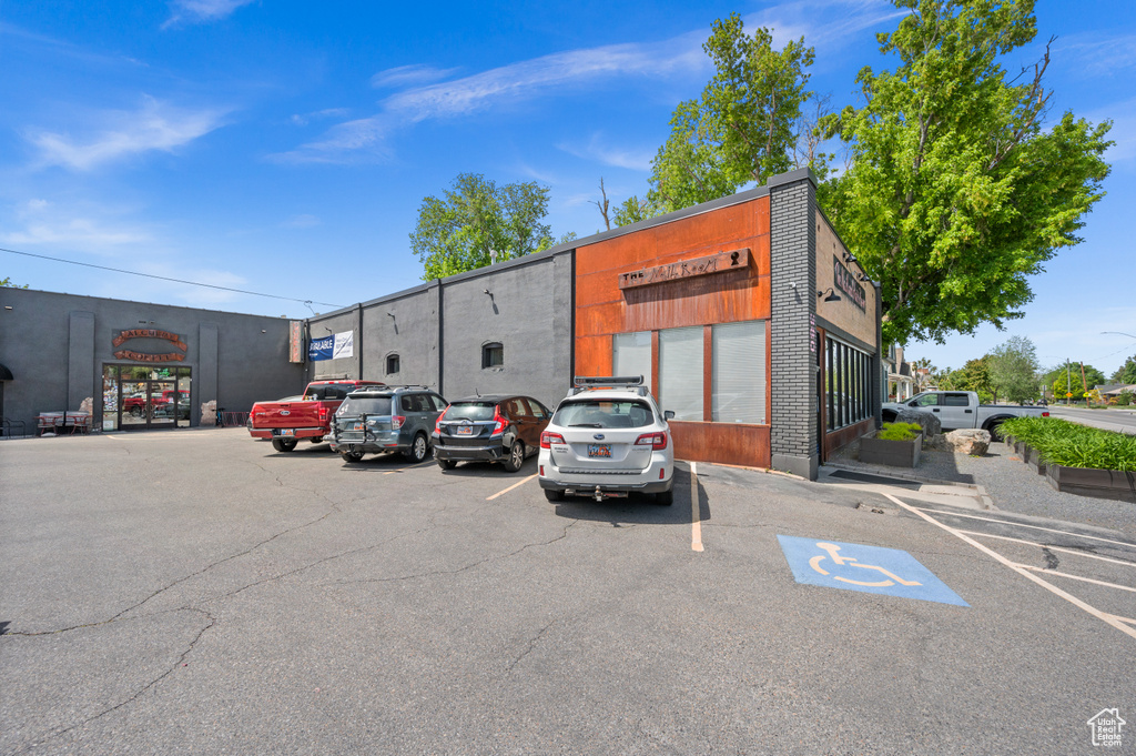 View of commercial property with uncovered parking