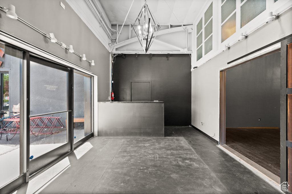 Bathroom featuring a high ceiling and concrete floors