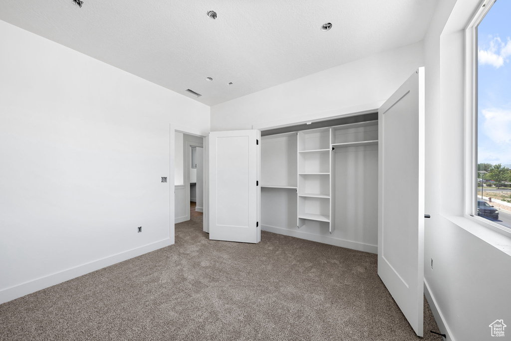 Unfurnished bedroom with carpet floors and a closet