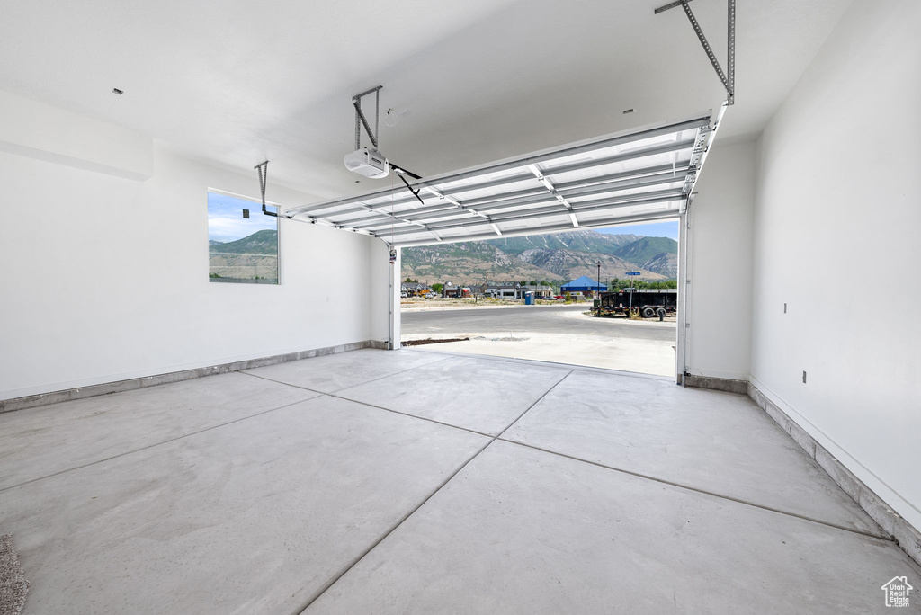 Garage with a mountain view and a garage door opener