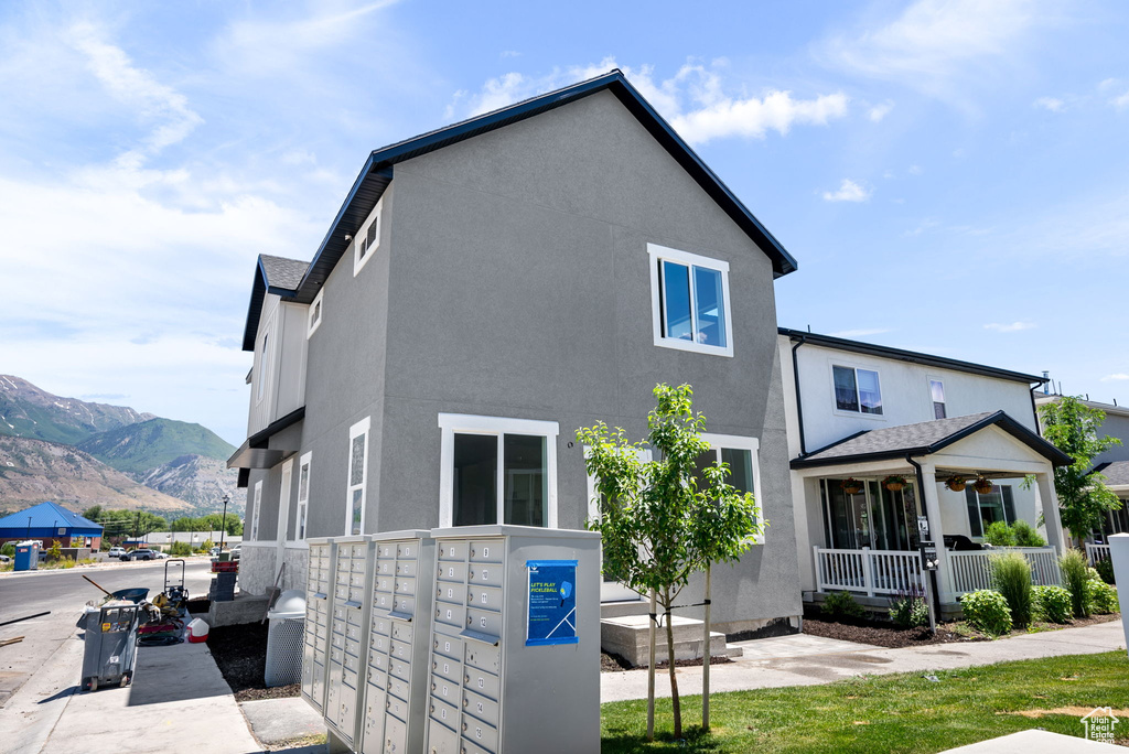 View of home\'s exterior with mail area, stucco siding, and a mountain view