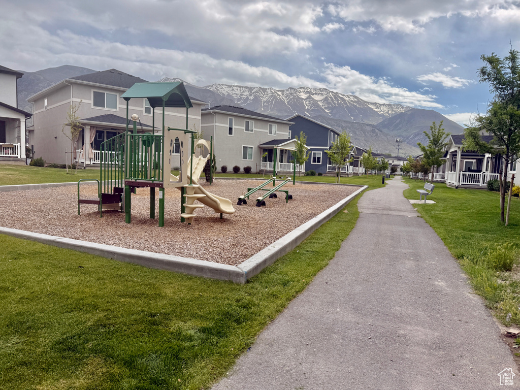 Community jungle gym featuring a mountain view, a lawn, and a residential view