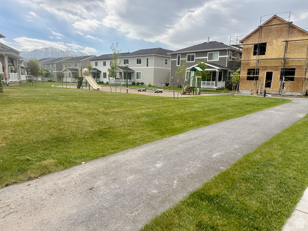 View of home\\\\\\\'s community featuring a residential view, a playground, and a yard
