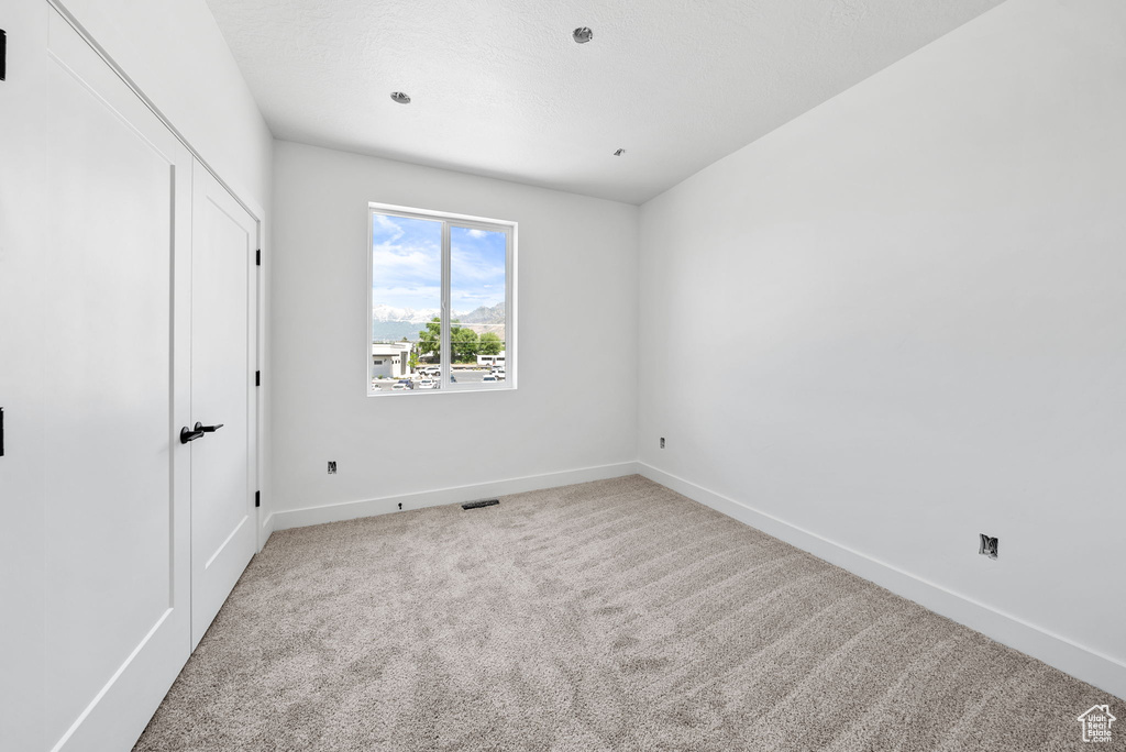 Unfurnished bedroom with carpet and baseboards