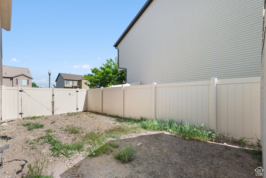 View of yard with a gate and fence