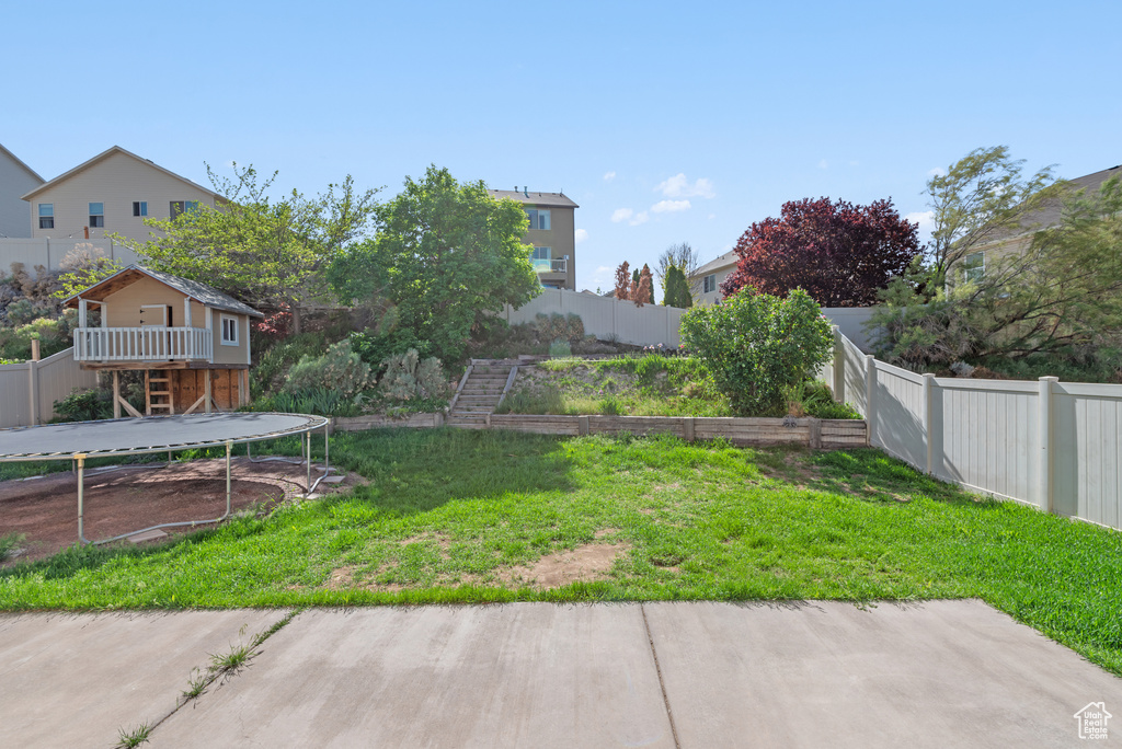 View of yard featuring a trampoline