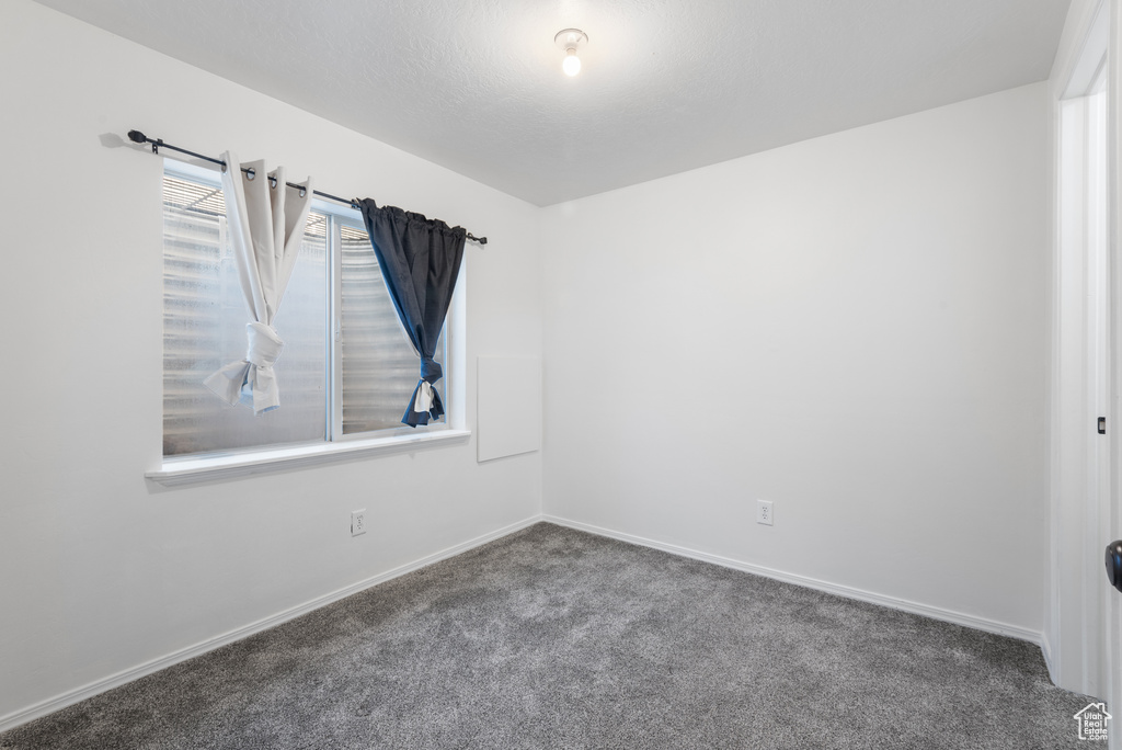 Empty room with carpet floors and baseboards