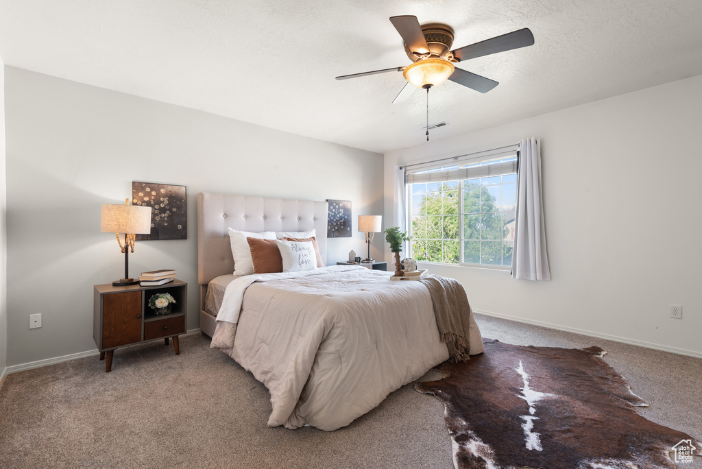 Bedroom with carpet floors, a ceiling fan, and baseboards