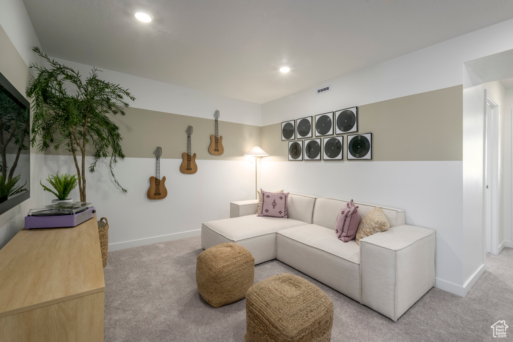 Living area with carpet, baseboards, and recessed lighting