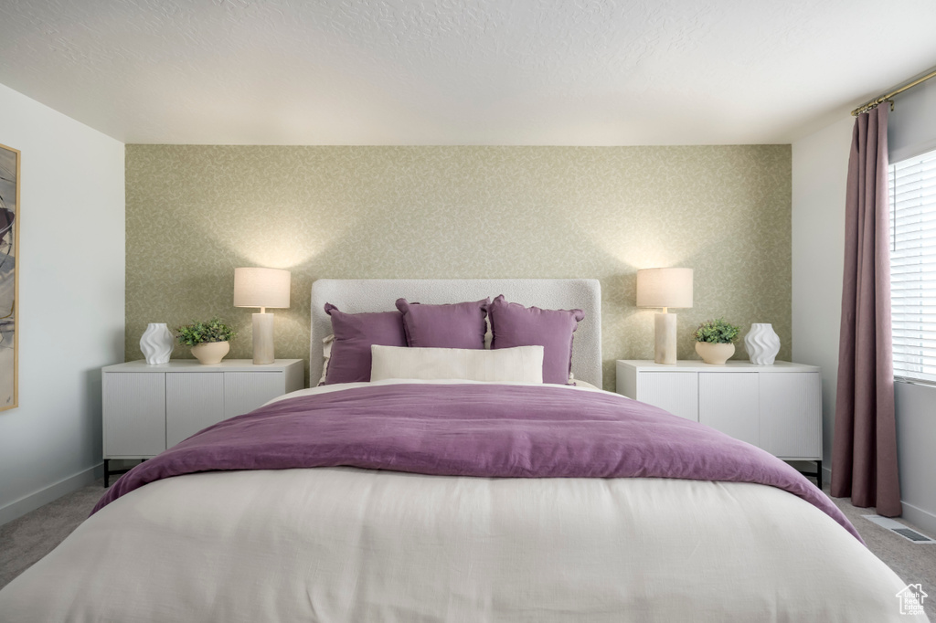 Bedroom with carpet floors and baseboards