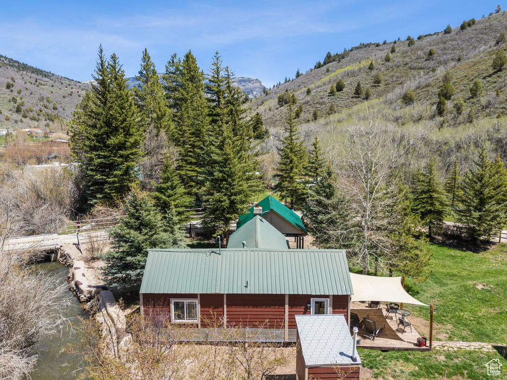 Back of property featuring a mountain view and metal roof