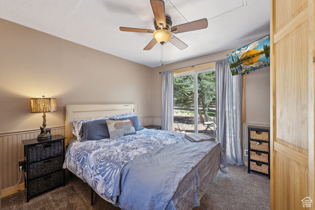 Carpeted bedroom with a ceiling fan