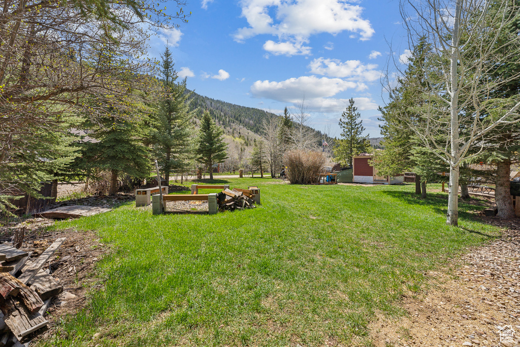View of grassy yard with a mountain view