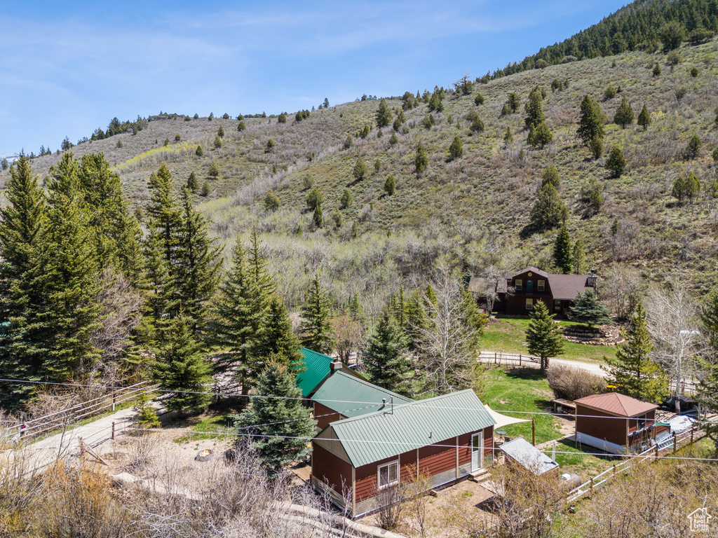Aerial view of property and surrounding area featuring a heavily wooded area
