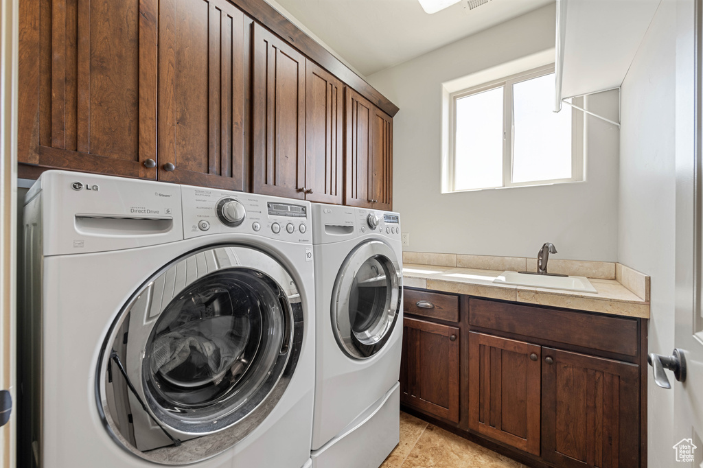 Washroom with cabinet space and independent washer and dryer