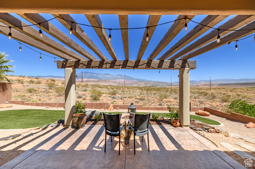 View of patio / terrace featuring a mountain view, a pergola, and a view of countryside