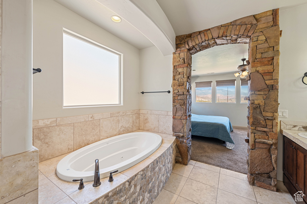 Full bathroom with vanity, tile patterned floors, ensuite bathroom, a whirlpool tub, and ceiling fan