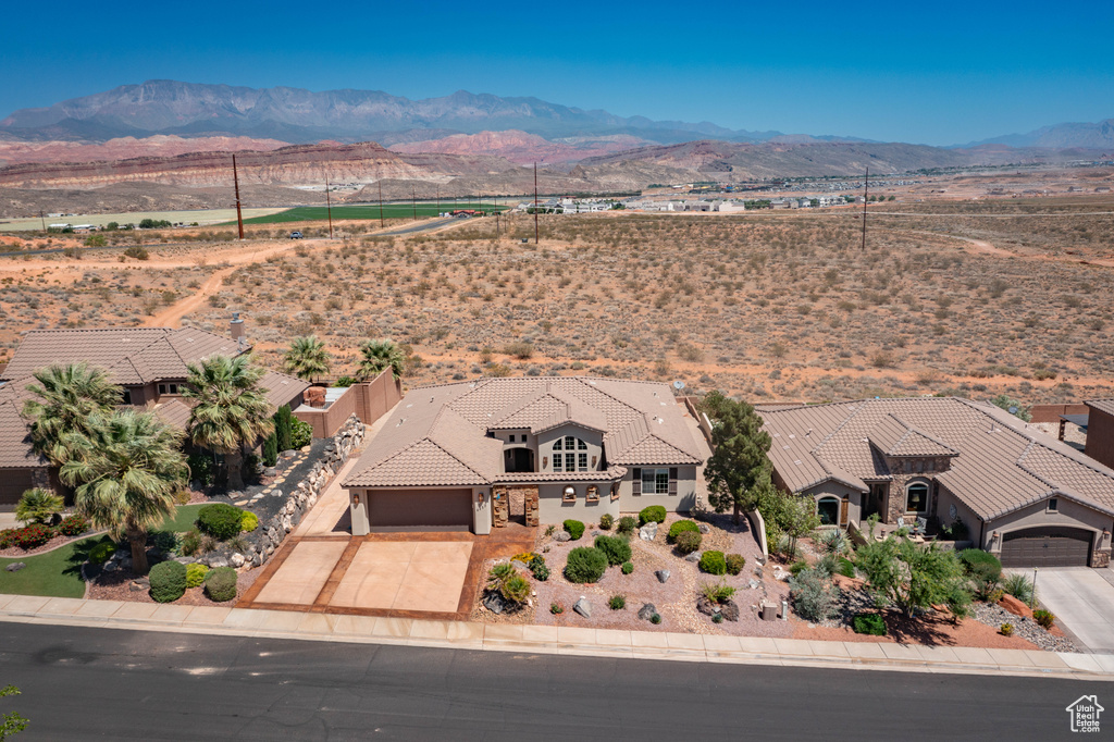 Aerial view of property and surrounding area featuring mountains