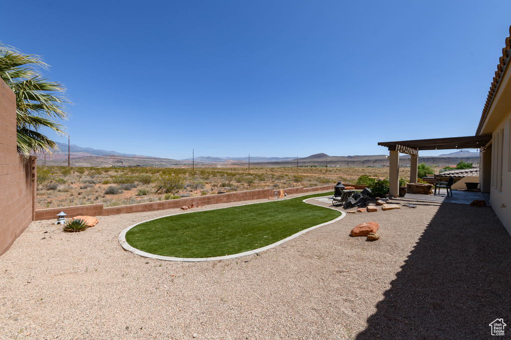 View of yard with a mountain view and a patio