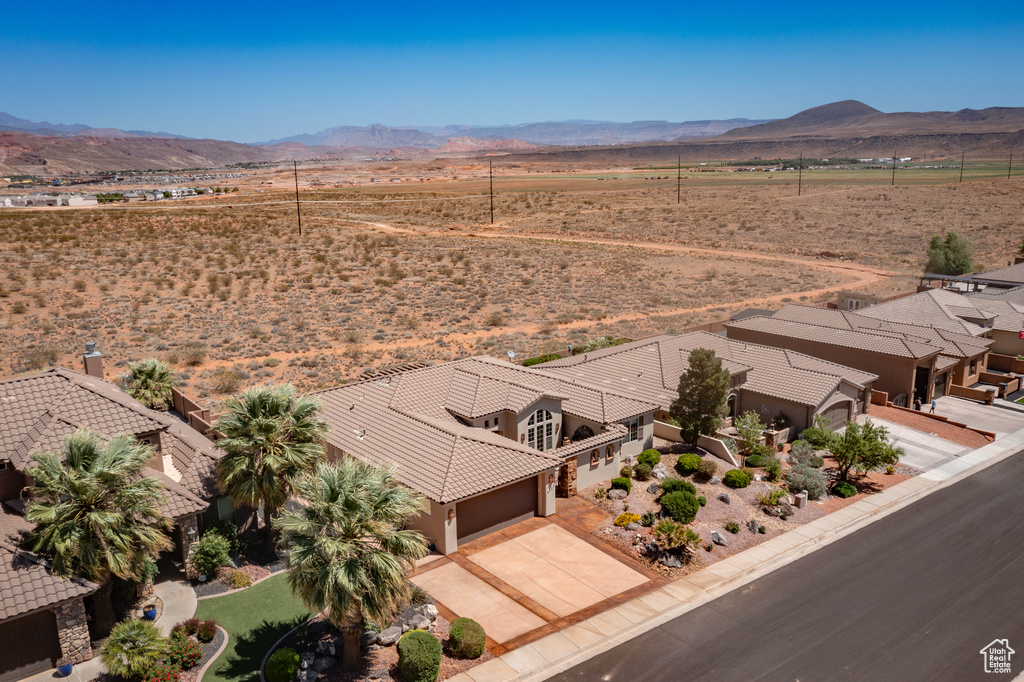 Aerial view of sparsely populated area featuring mountains and a desert landscape