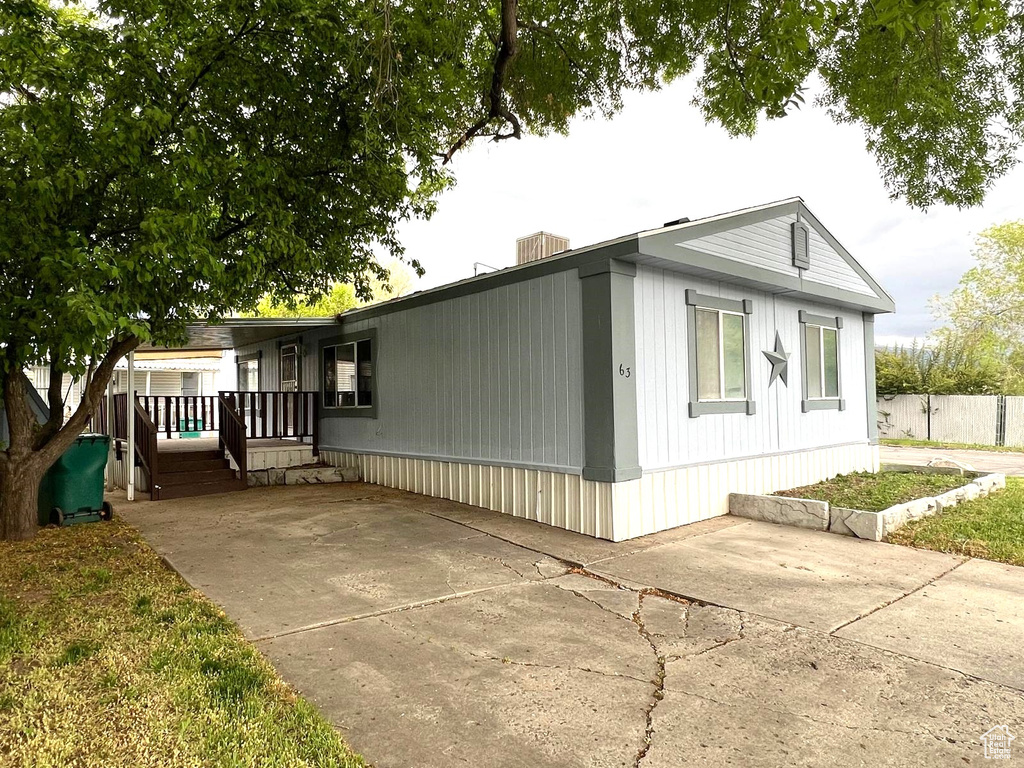 View of front facade featuring a patio and fence